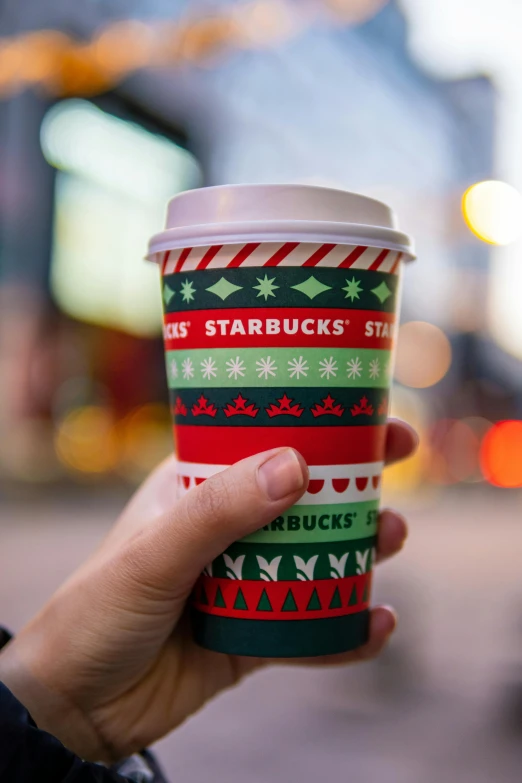 a starbucks cup that is decorated with christmas decorations