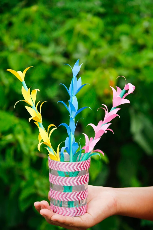 a person holding out soing with colorful feathers