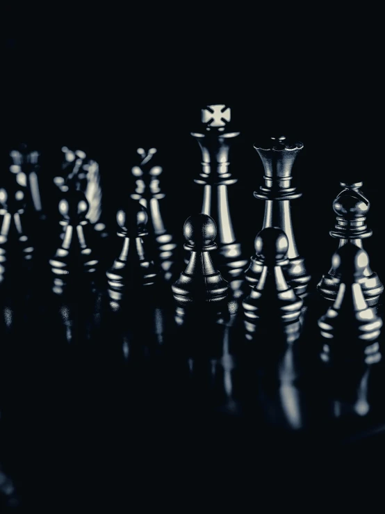 an image of several metallic chess pieces on a table