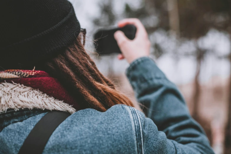 a girl wearing a beanie and blue jeans