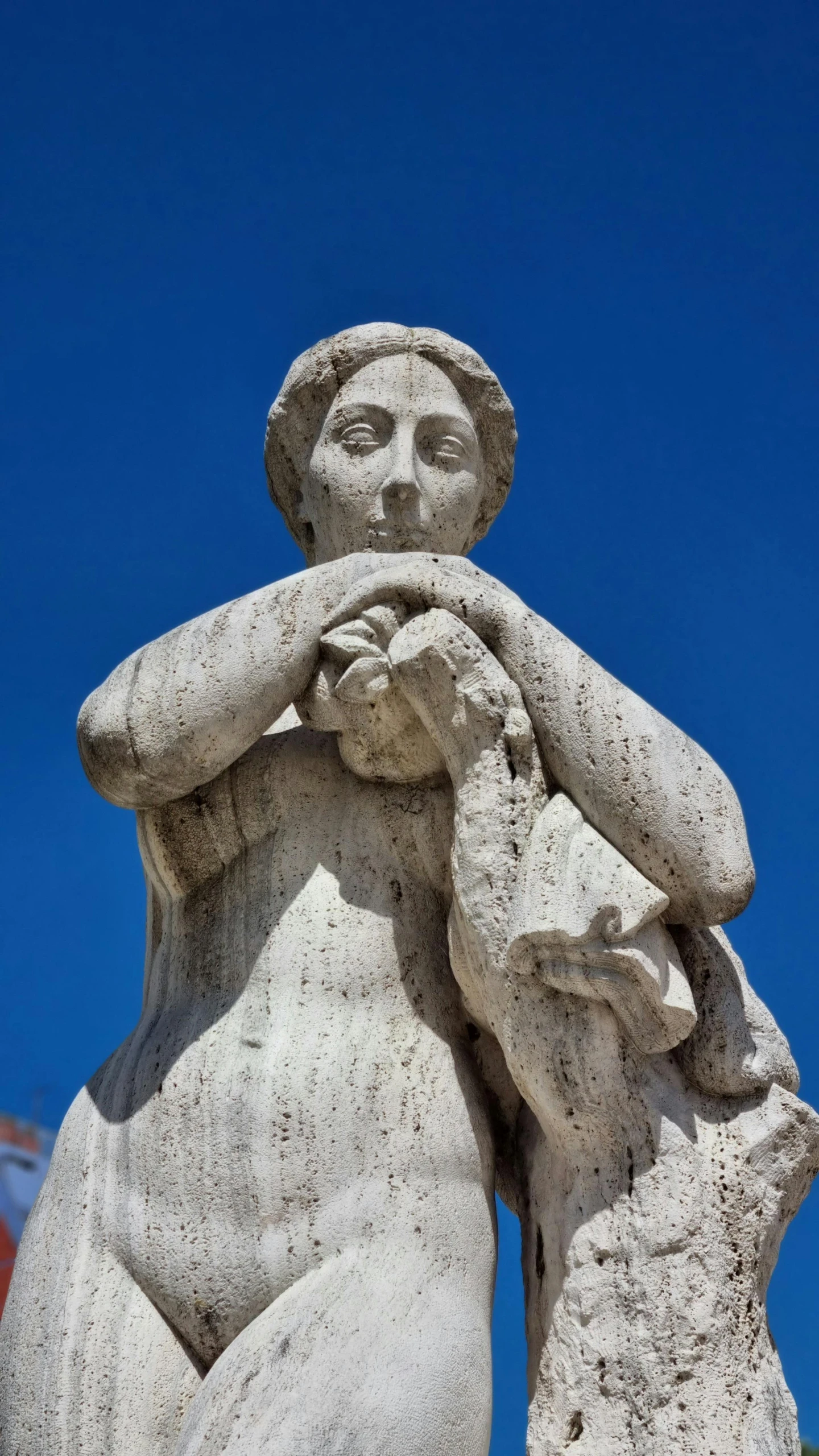 a large stone statue of an angel holding a baby