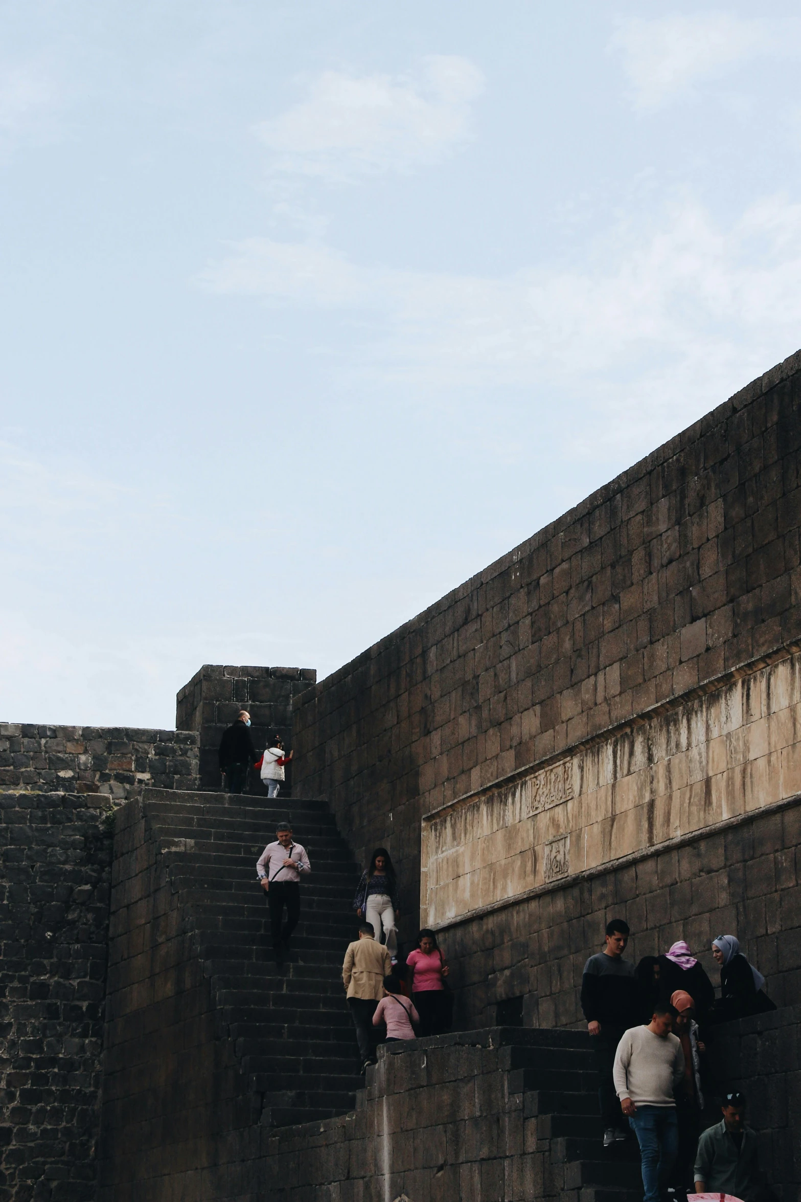 many people with their bags climbing some stairs