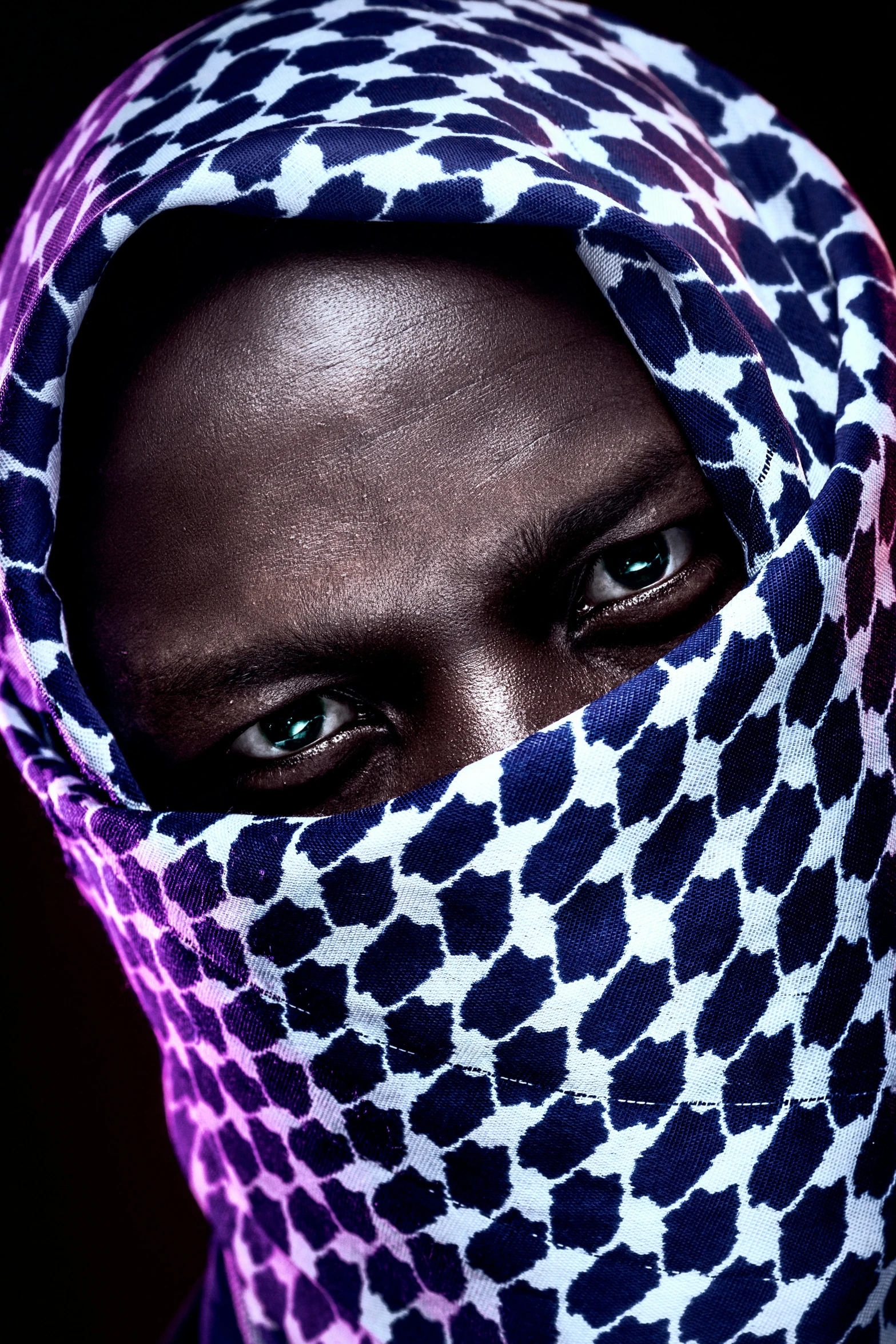 a woman with very bright skin and a patterned head cover