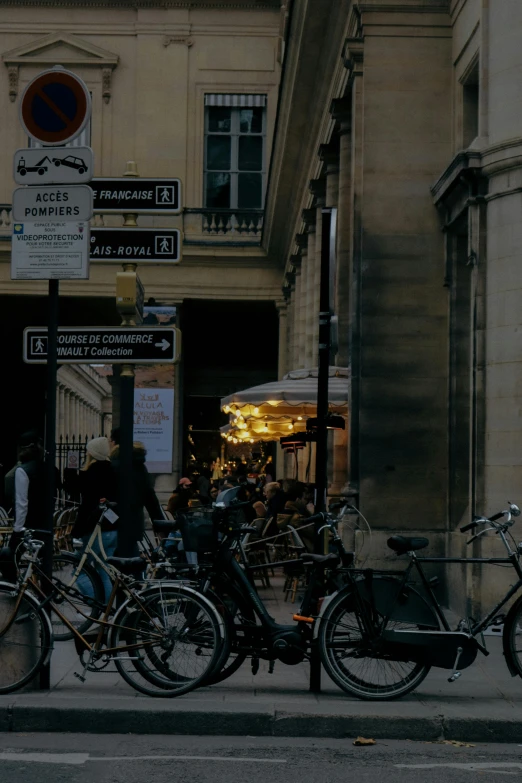 many bicycles are parked next to the curb