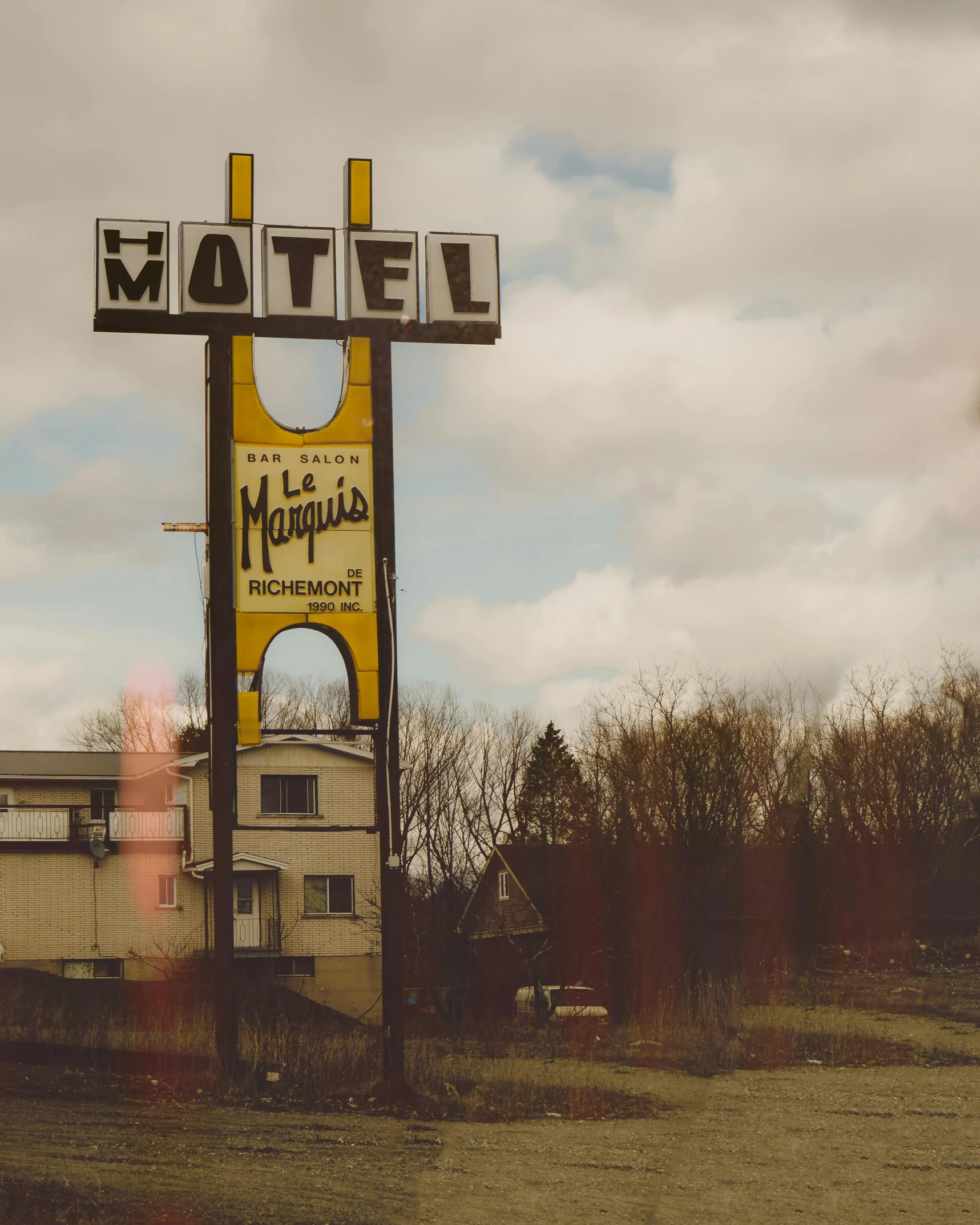 an old building and sign in the out country