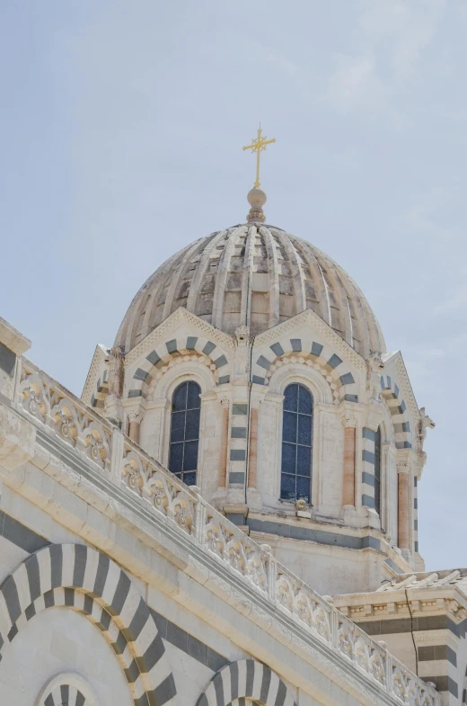 the dome of the church has windows and a cross on top