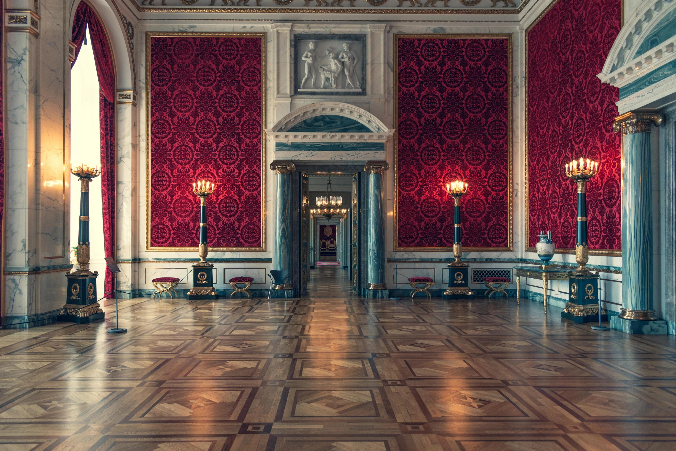 a building with a wooden floor with red wallpaper