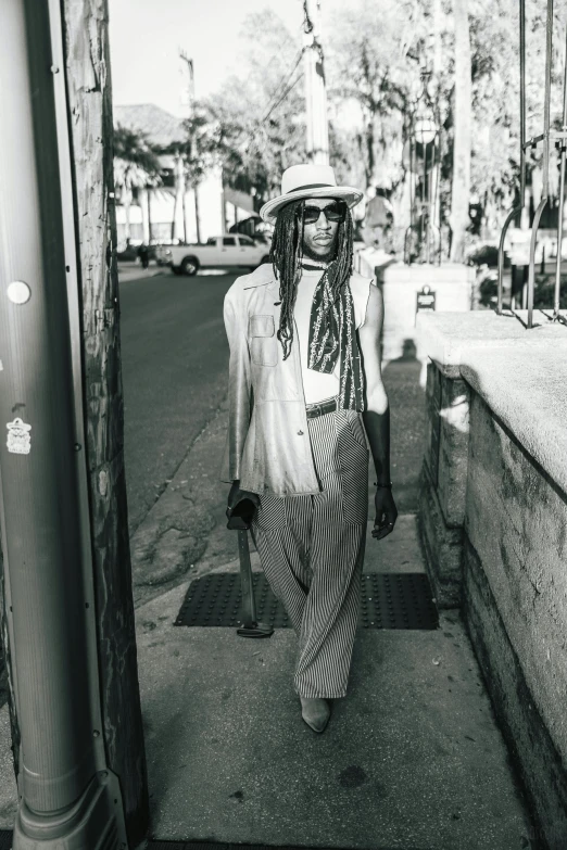 a person is walking down the street wearing a hat