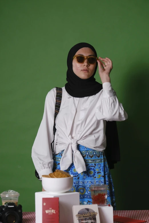 a person wearing sunglasses and a head scarf