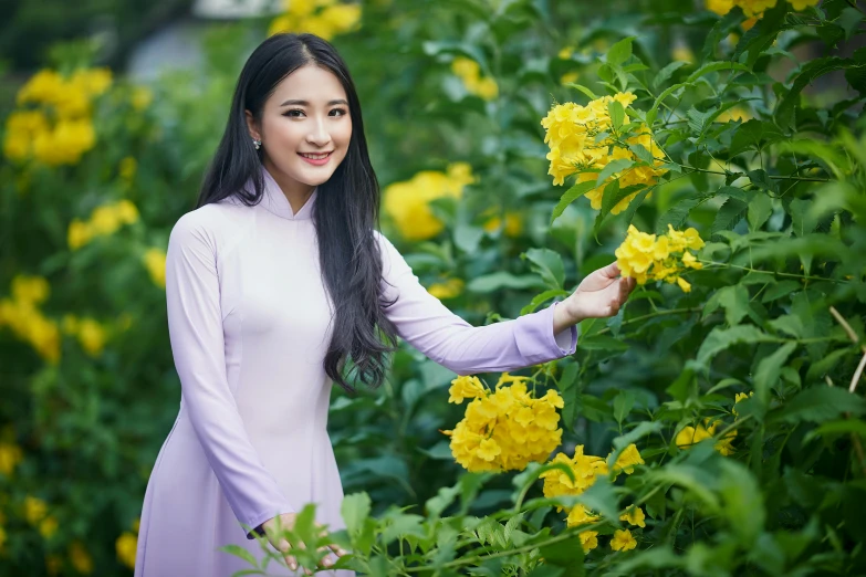 a woman is posing for a picture among flowers