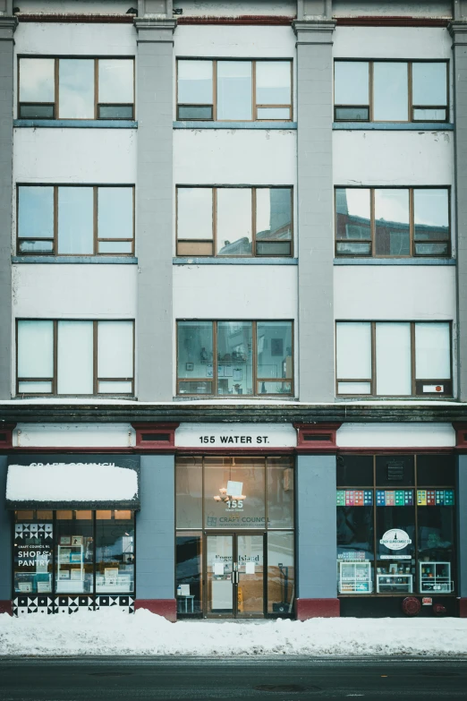 an old, snowy looking storefront in winter