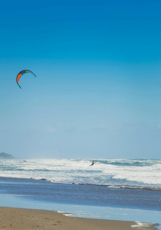 a person parasailing in the ocean on a sunny day