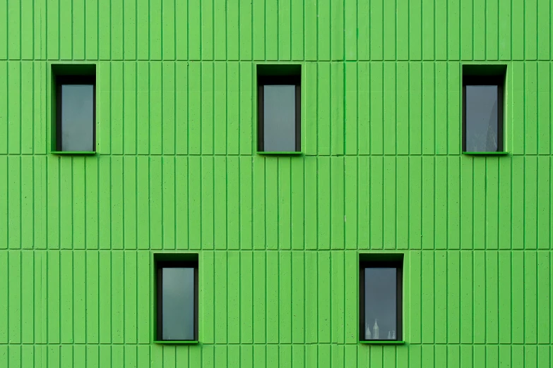 a green building has six windows and a clock