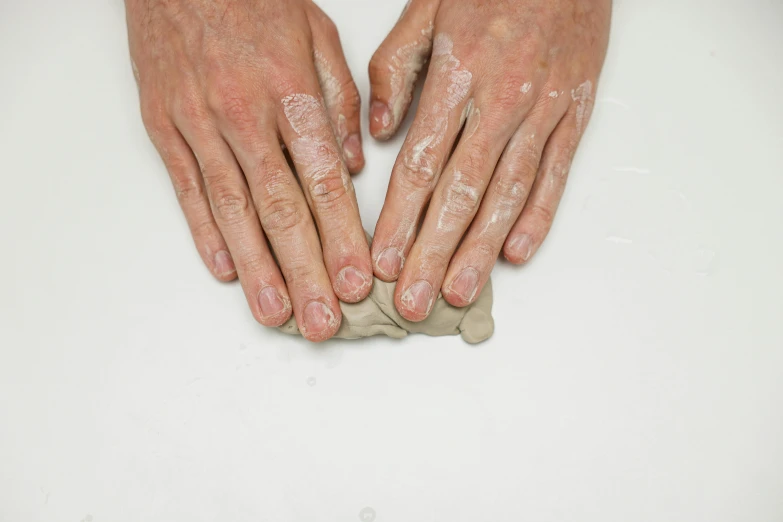 the fingers on a table are covered with white powder