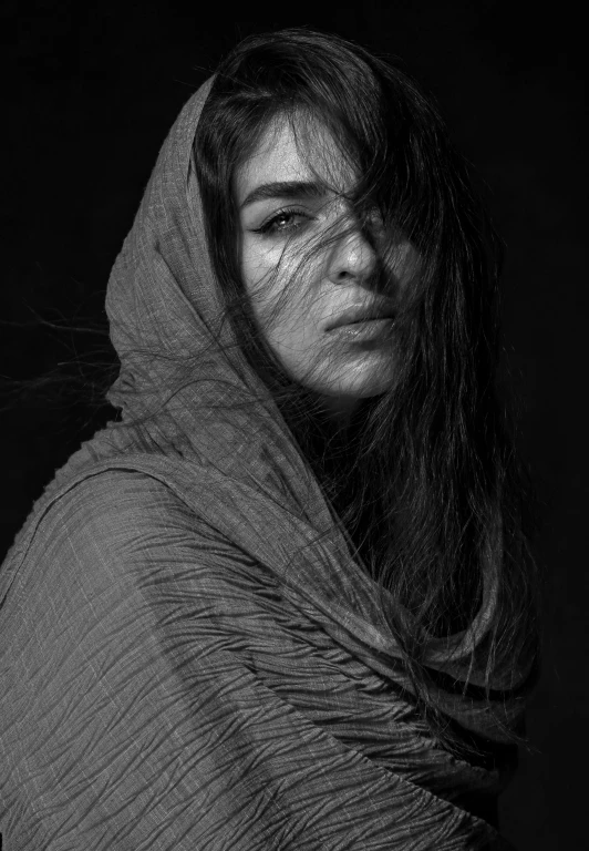 black and white portrait of a woman wrapped in a blanket