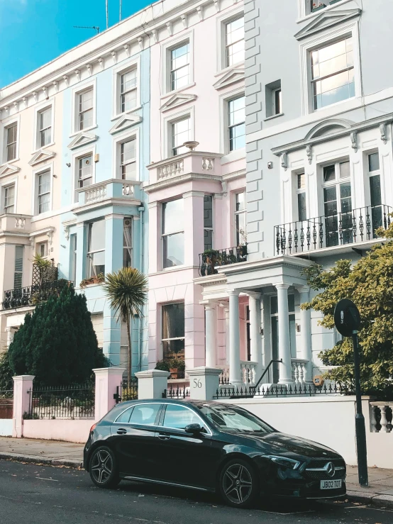 a row of pastel pink and blue houses