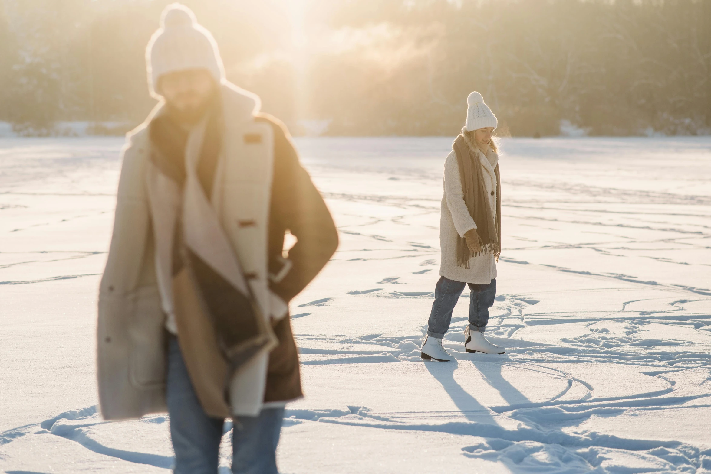 a man standing in the snow with another man standing next to him