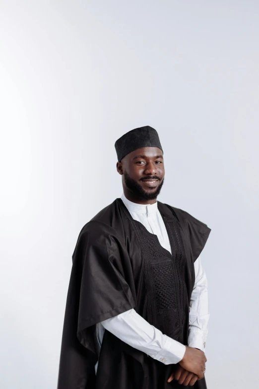 a man wearing black, white and red poses for the camera