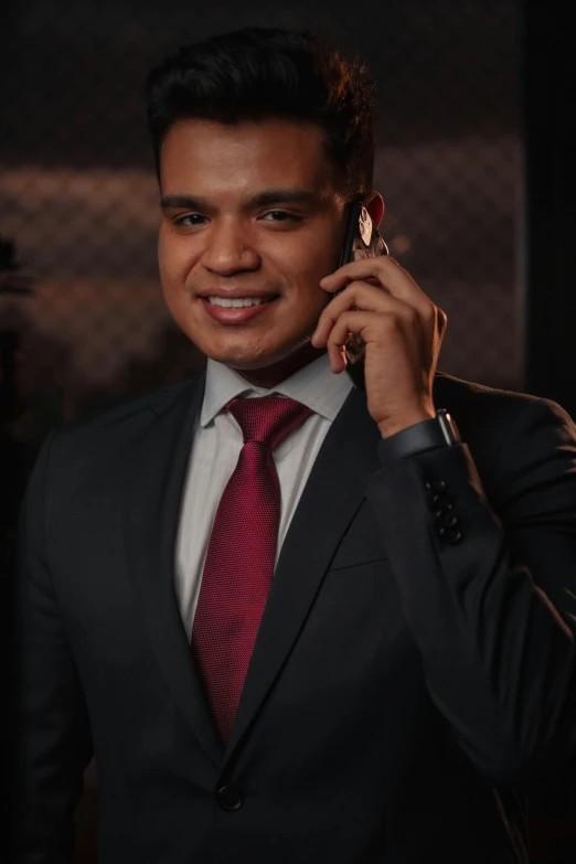 a man in suit talks on the phone