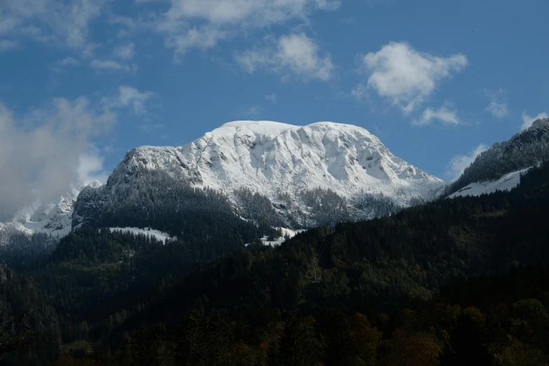 snowy mountain tops can be seen from the bottom of this po