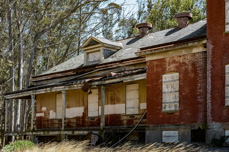 a dilapidated building with boarded up windows and boarded doors