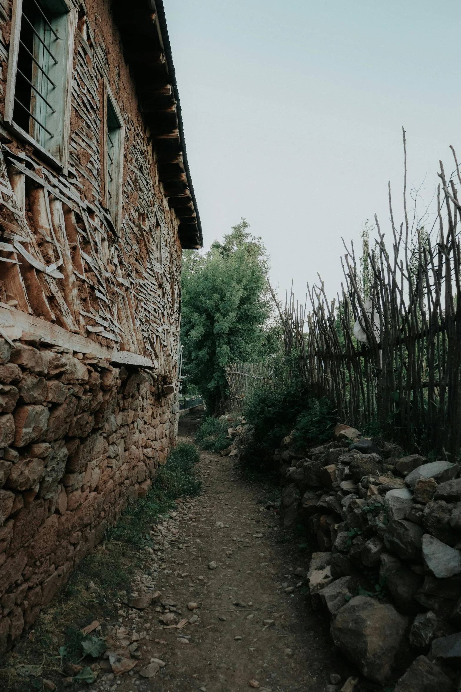 dirt path leading up to a small brick building