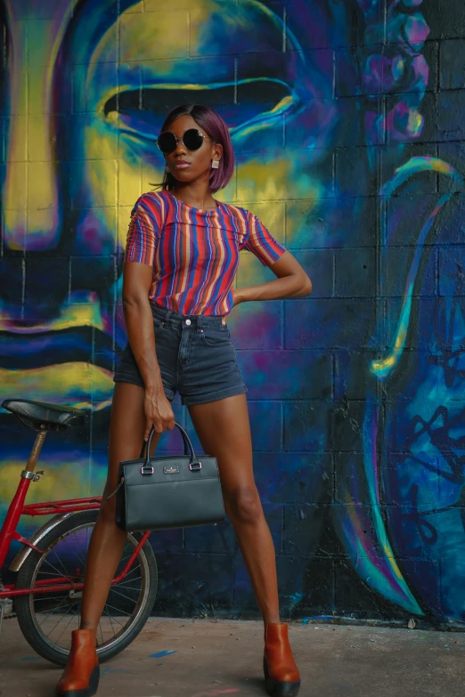 a woman is standing near a wall with graffiti