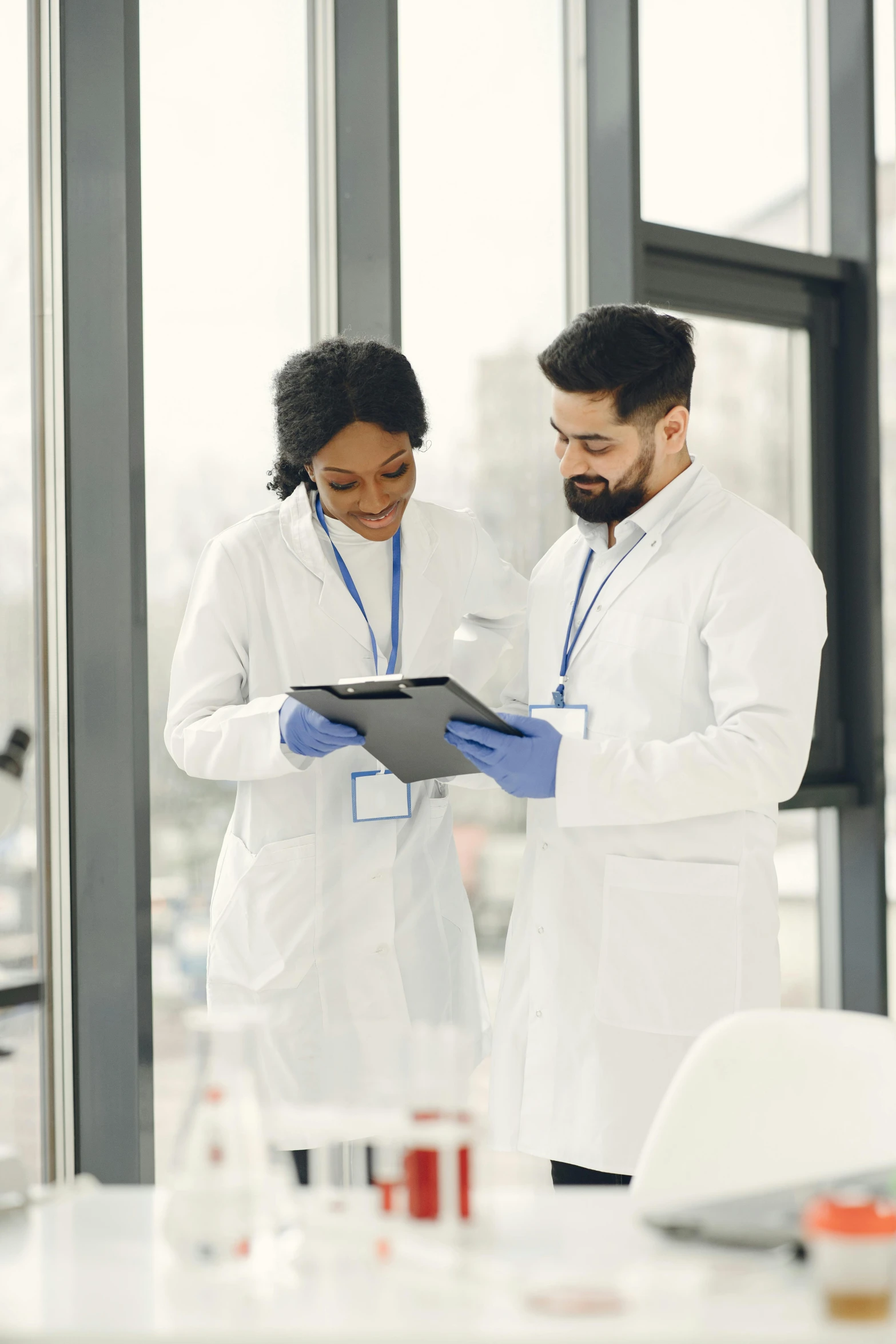 two people in white coats standing next to each other