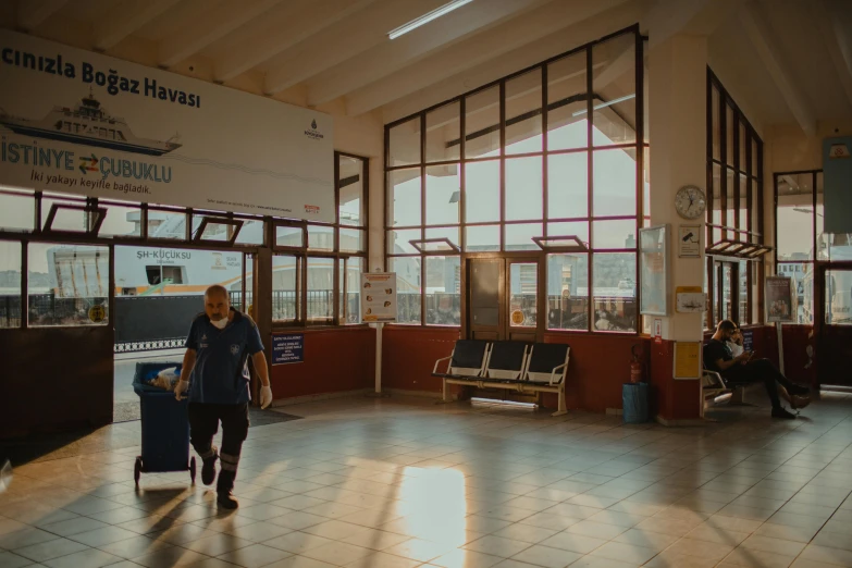 a man holding his luggage in front of a terminal