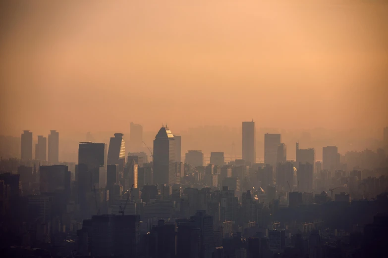 a city skyline in the haze as seen from high above