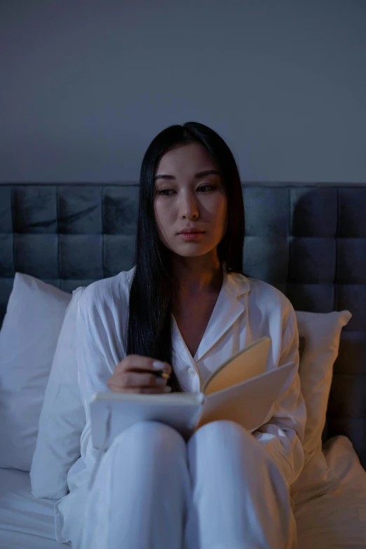 a woman is looking at a piece of paper she is reading