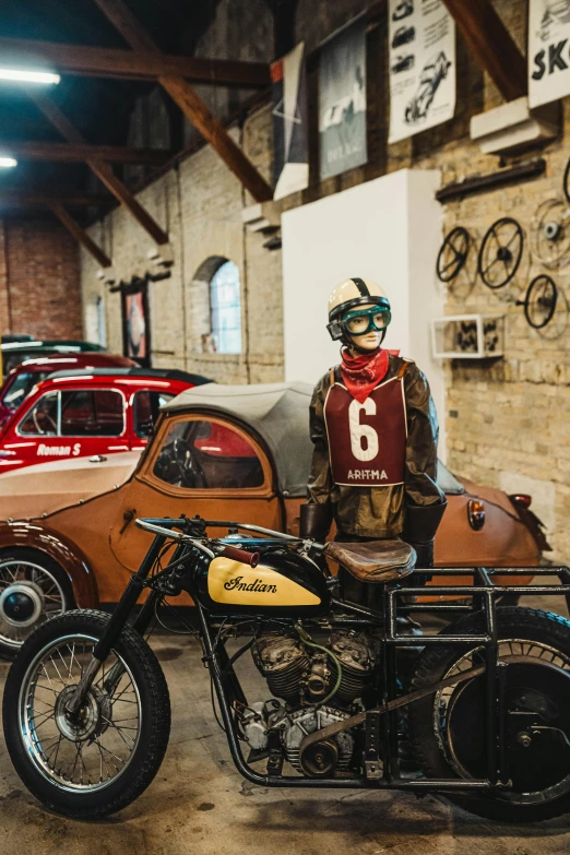 a motorcycle parked in a garage next to a car