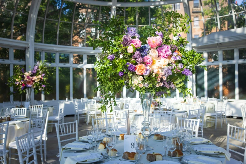 an elegant floral centerpiece sits on the dining room table