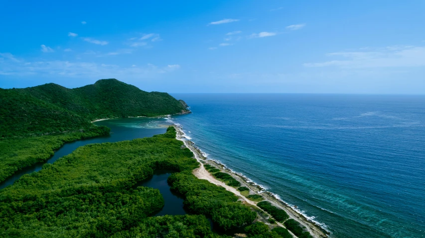 a river next to some small mountains by a beach