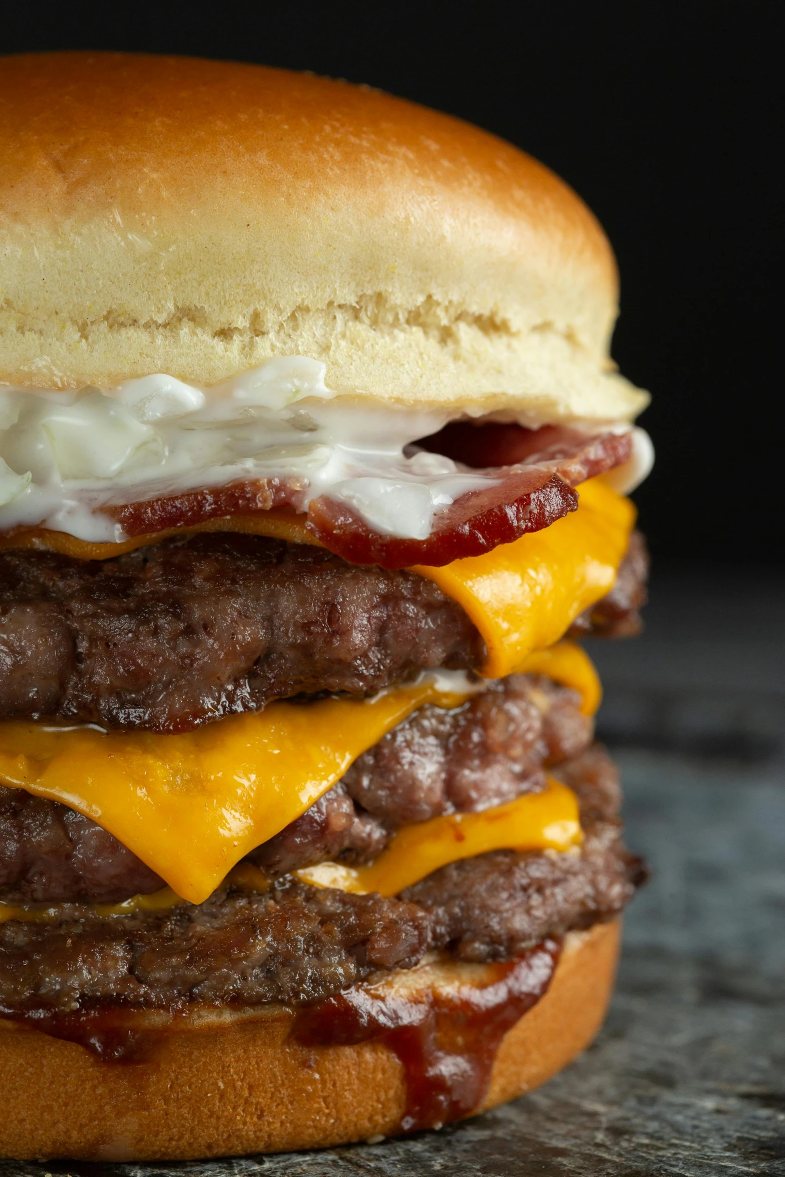 a close up of a cheeseburger with bacon