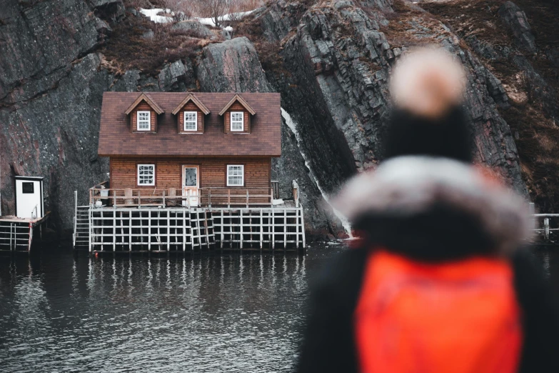 a house sitting on a dock in a mountain