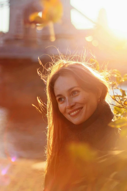 a woman smiles while looking into the camera