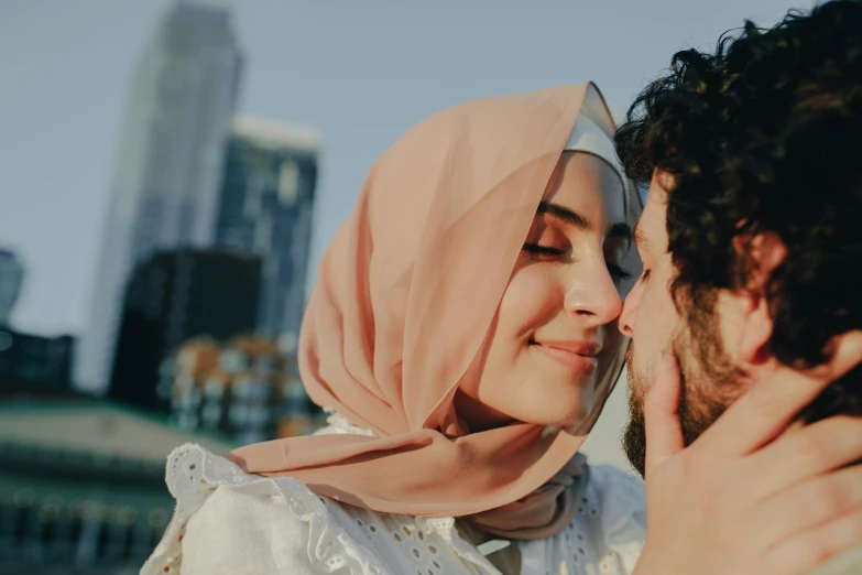 a man and a woman kissing in a city