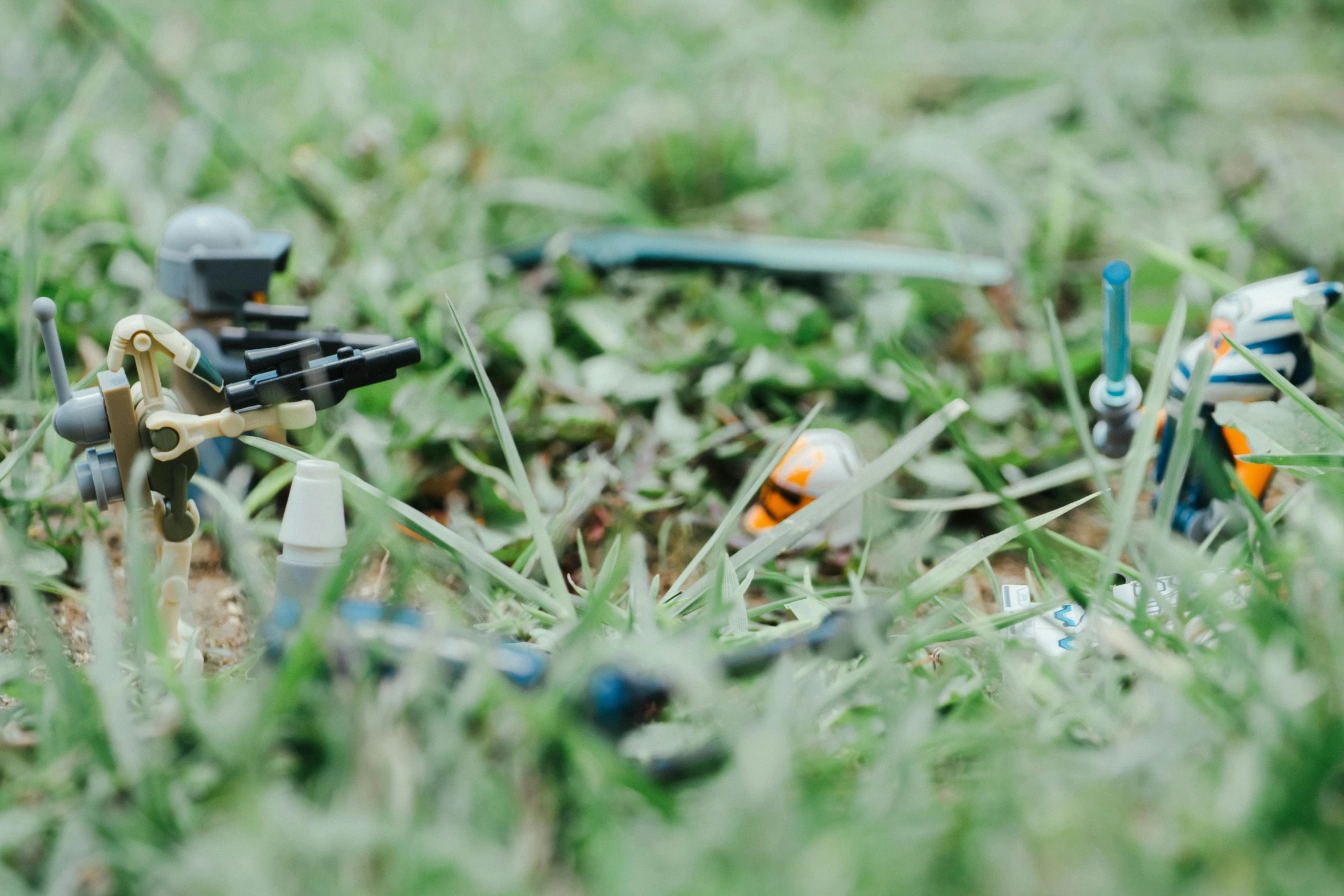 there is small plastic toys in the grass