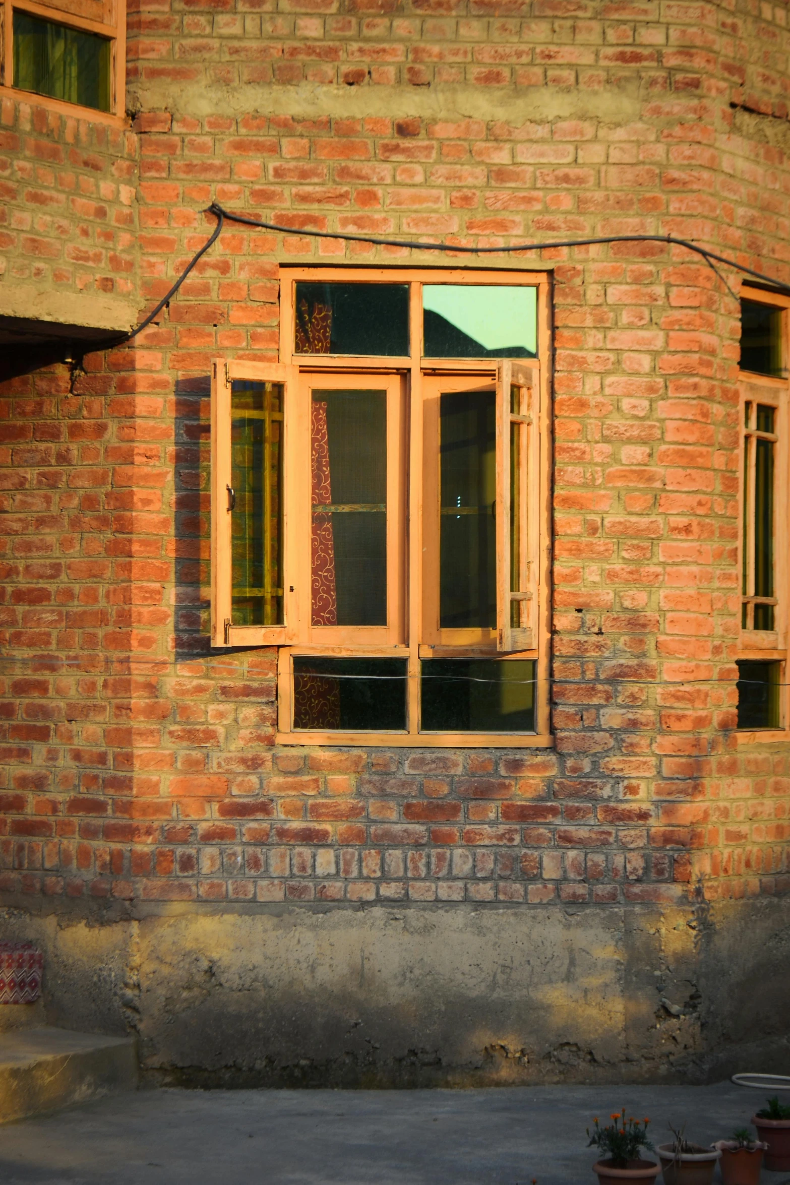 a brick building with windows made of wood