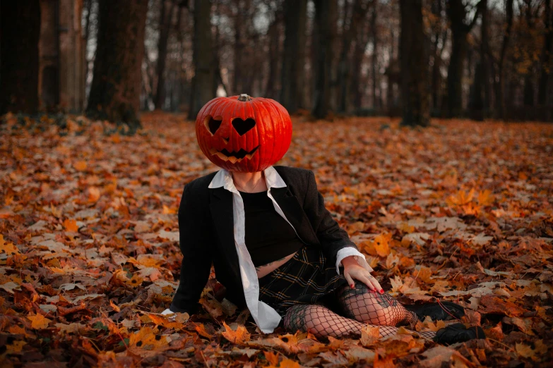 a woman wearing a costume sits in a leaf covered forest