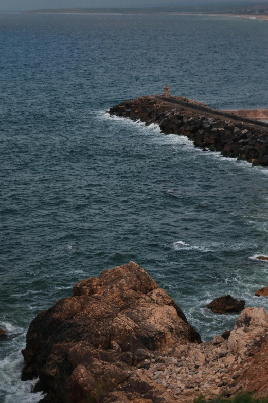 a person standing on top of a rocky hillside