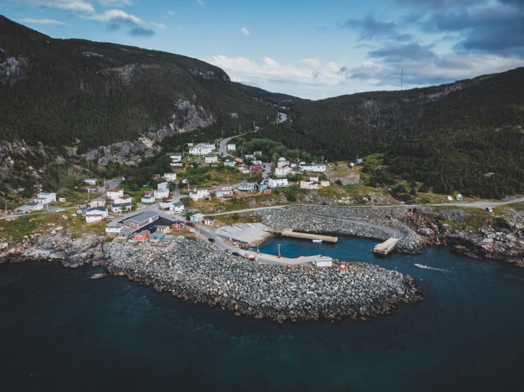 an aerial view of some houses in a small area near a body of water