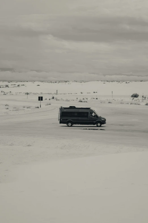 black and white pograph of an old car in the snow