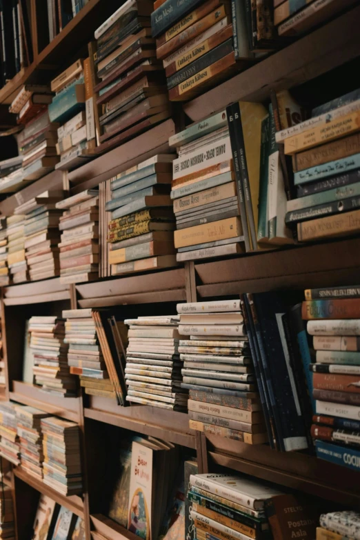 a wall of books stacked high up on the wall