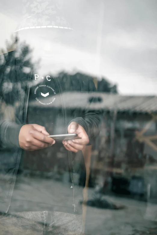 the reflection of a person holding a smart phone