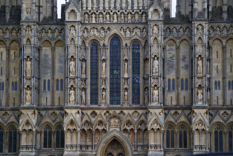 large cathedral building with a clock and statues on it