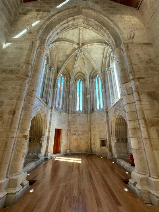 the interior of a building with wooden floors and windows