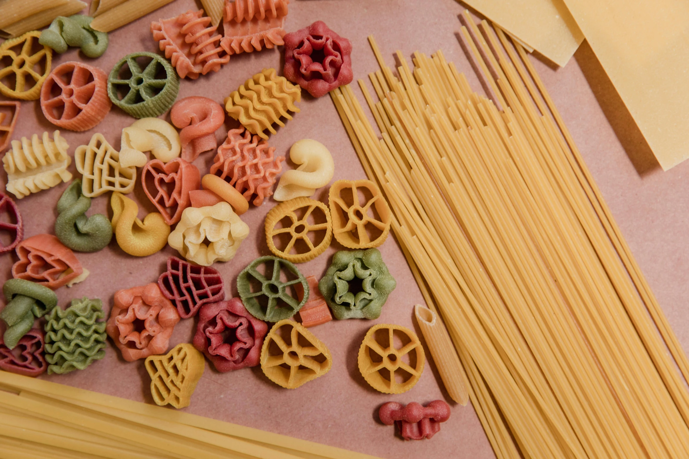 a few pastas with some colorful items next to them
