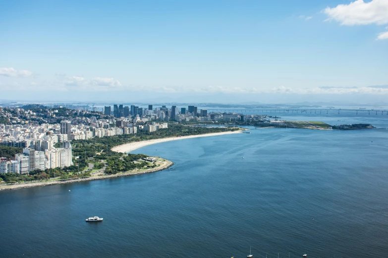 a boat is sailing near the shore in a city